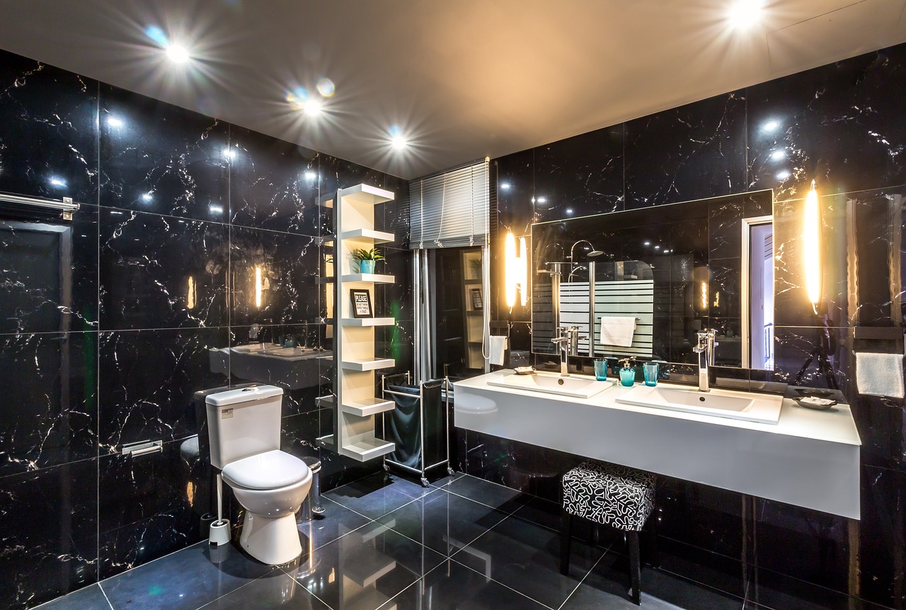 Modern black marble bathroom with sleek fixtures.