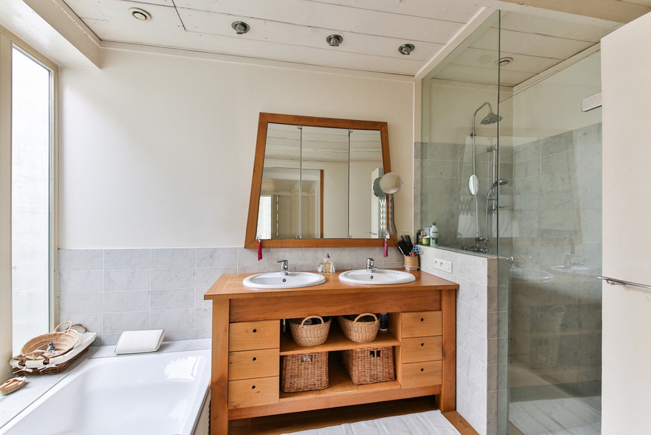 Wooden vanity with glass-enclosed shower and tub