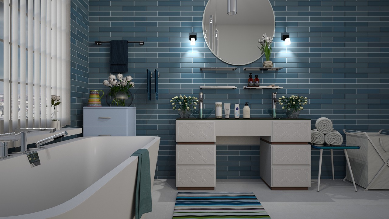 Blue-tiled bathroom with vanity and bathtub elegance