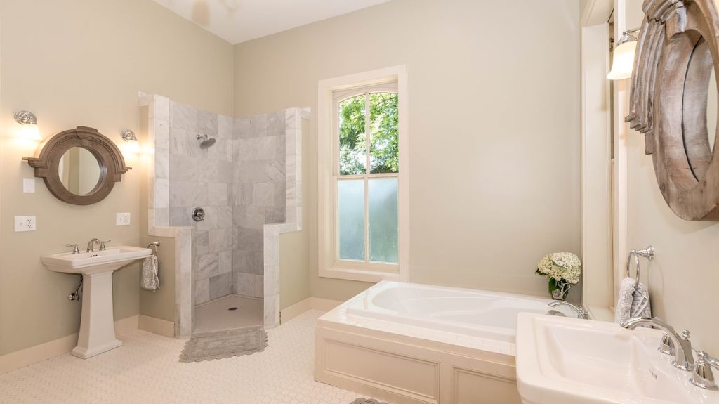 Spacious bathroom with corner shower and tub