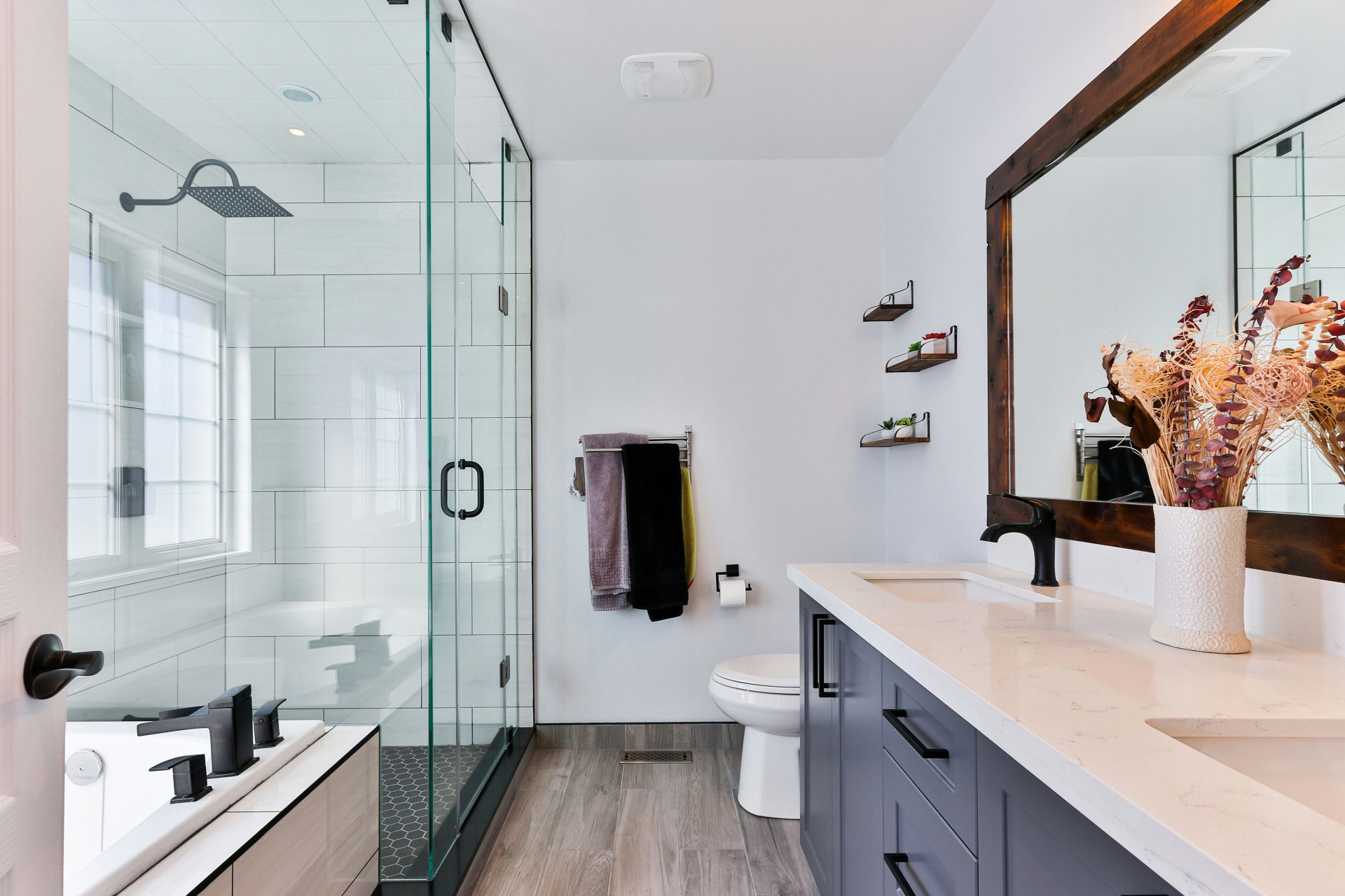 Bright bathroom featuring glass shower and vanity