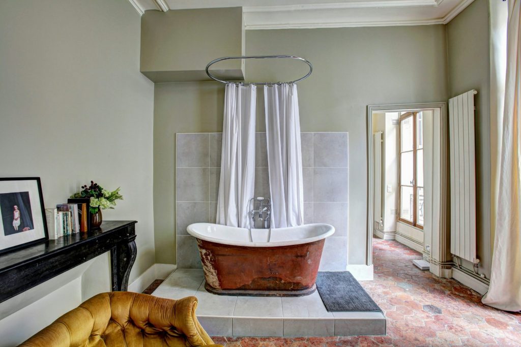 Rustic tub with curtain in vintage setting